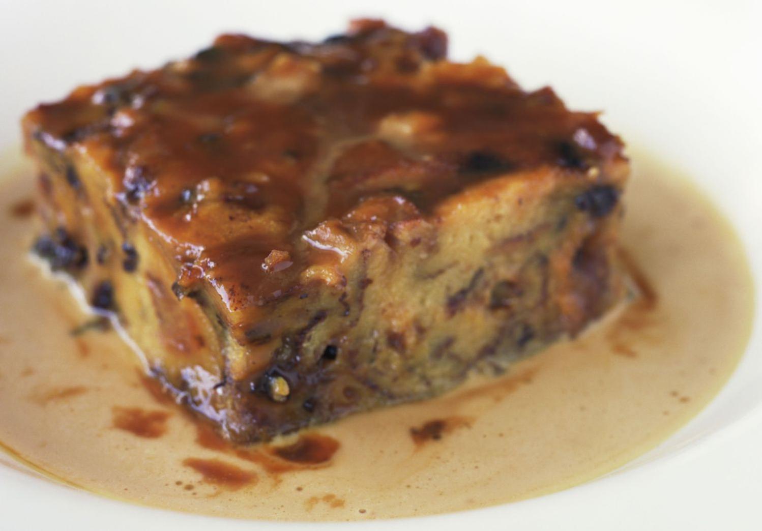  A baking dish filled with the bread pudding mixture, overflowing with flavor.