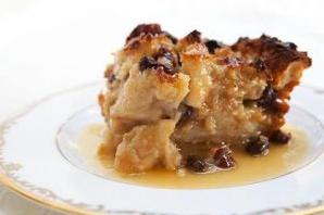  A close-up of the bread pudding with raisins, cinnamon and sugar on top.