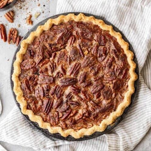  A slice of pecan pie with a dollop of whipped cream is pure decadence.