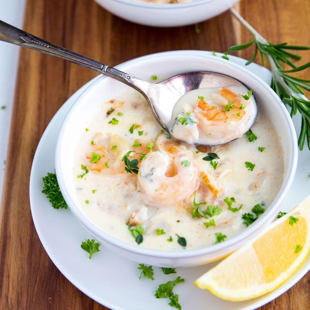  Fresh and succulent seafood swimming in a bowl of creamy goodness.