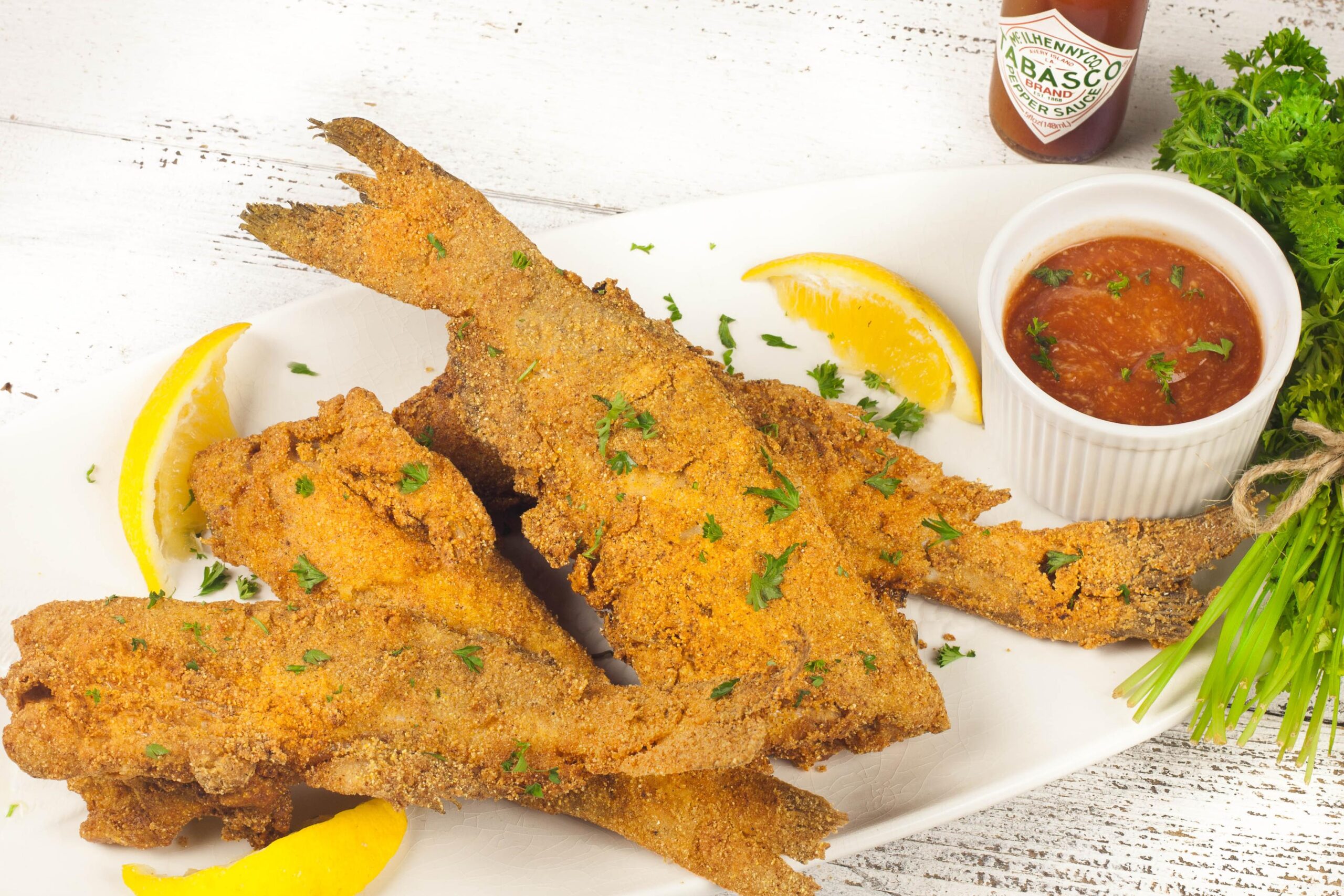  Giving our catfish a quick dip in buttermilk is the first step to achieving a crispy crust.