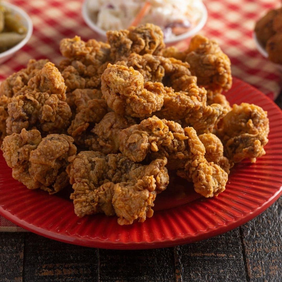  Once your gizzards have soaked in the buttermilk, it's time to coat them in a flavorful breading mixture.