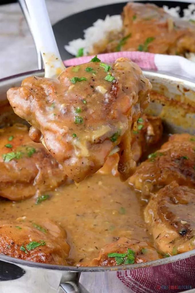  Perfectly browned chicken thighs drenched in flavorful gravy