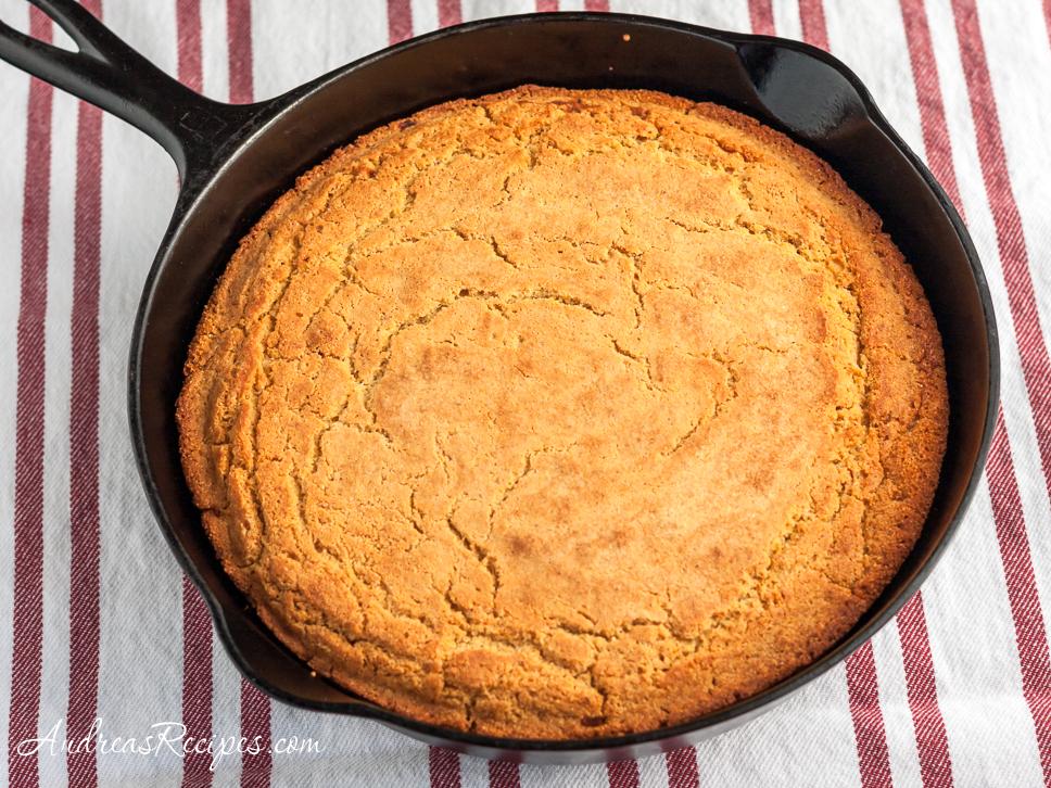  The golden, crusty exterior of the cornbread conceals a soft, fluffy interior.