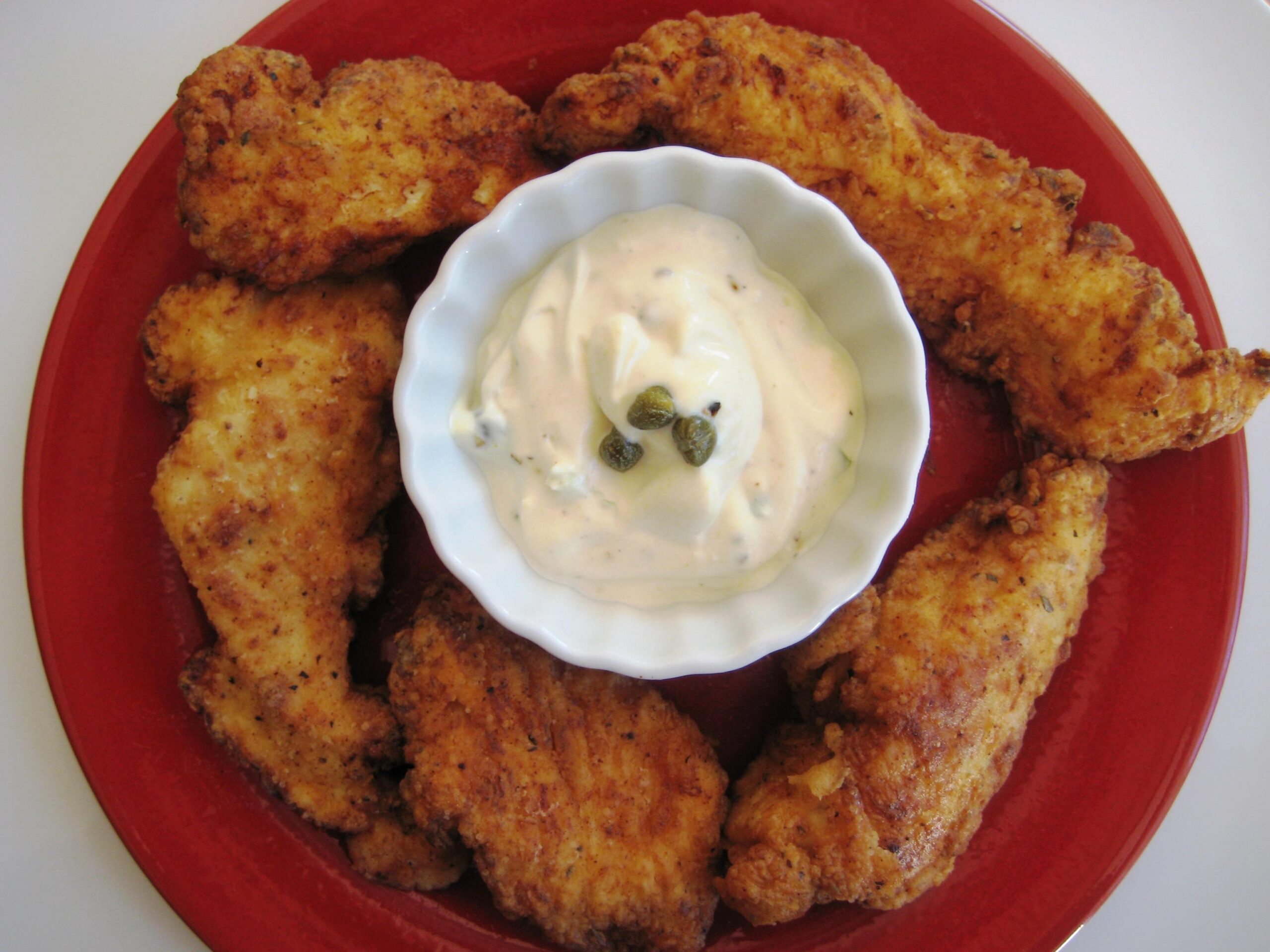  The green peppercorn mayo brings a tangy and savory flavor to the dish.