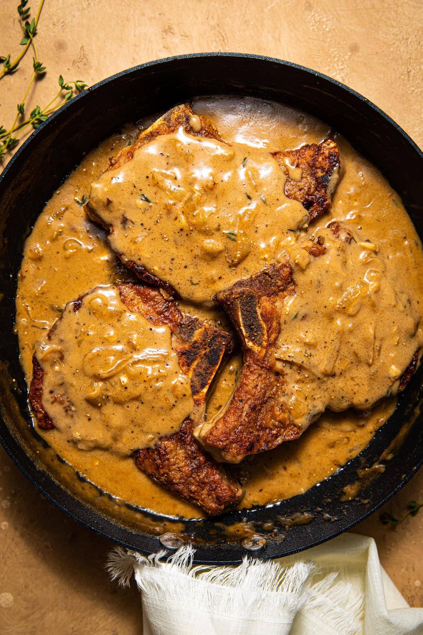  These juicy pork chops are smothered in a rich brown gravy that will make your taste buds dance.